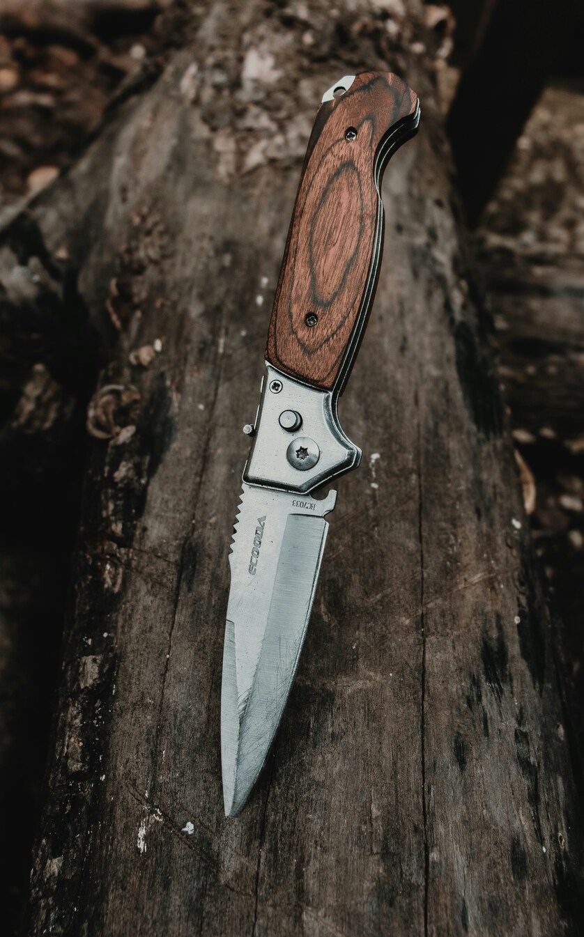 Knife sticked into piece of wood